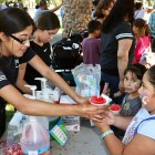 Youngsters enjoy fresh, cool watermelon at National Night Out.